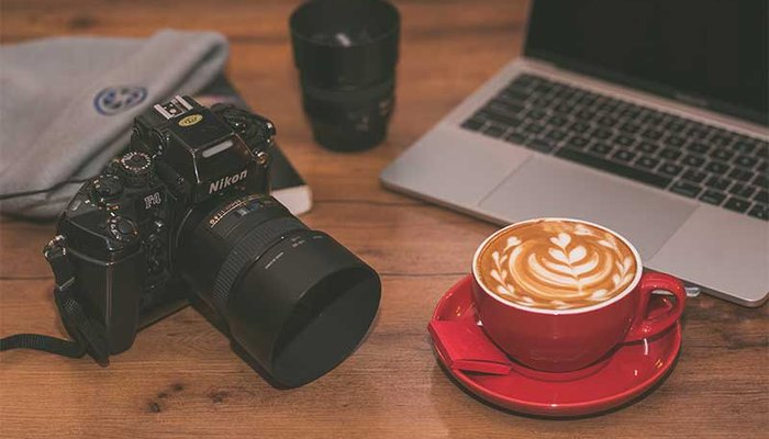 laptop, camera and a hot cup of coffee